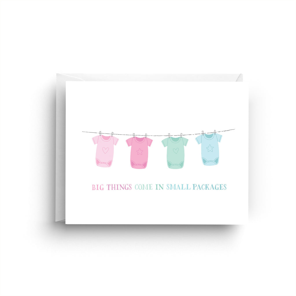 Card with baby clothes on a line and text 'Big things come in small packages' on a white background