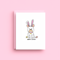 Greeting card with a dog wearing bunny ears on a pink background
