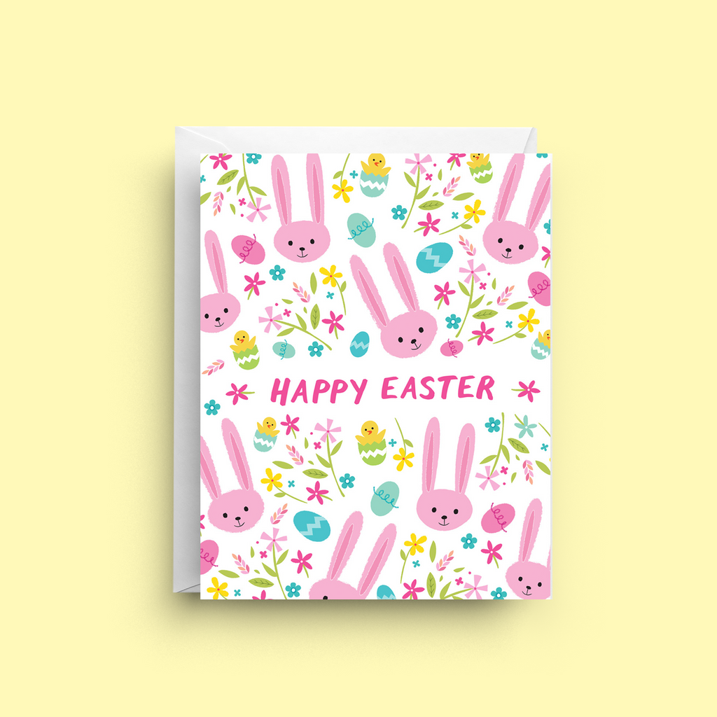Easter-themed greeting card with pink bunnies, eggs, and flowers on a white background