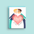 Greeting card with illustration of two people holding a heart with 'LOVE IS ALL YOU NEED' text on a light blue background