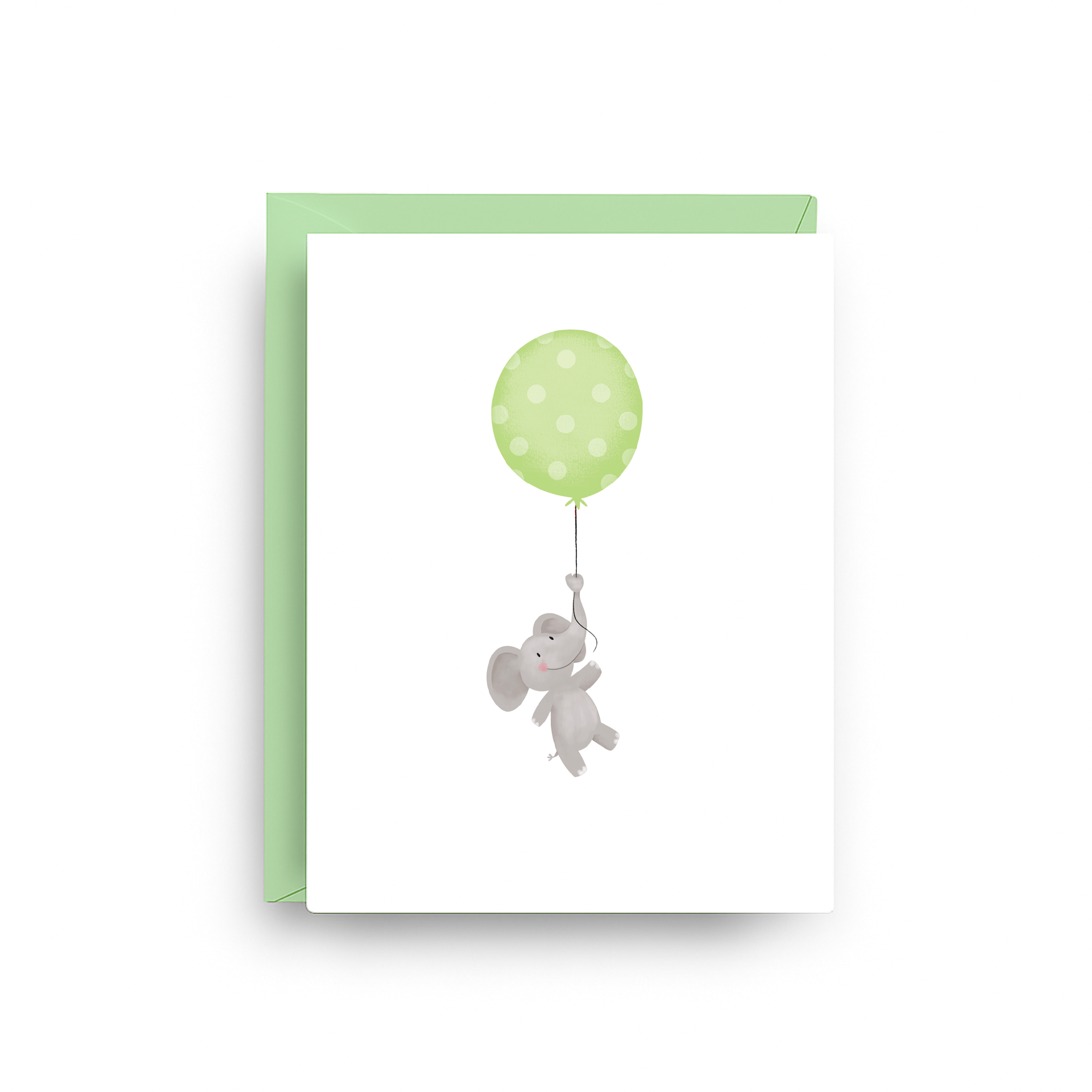 Greeting card with a green polka dot balloon and gray elephant on a white background