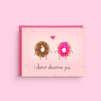 Card with cartoon donuts and text 'i donut deserve you' on a pink background