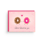 Card with cartoon donuts and text 'i donut deserve you' on a pink background