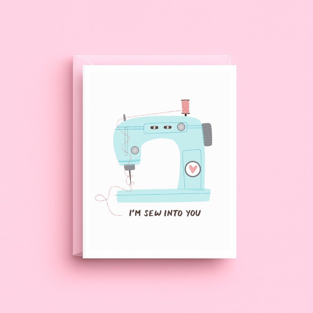 Illustrated vintage blue sewing machine with heart greeting card with I'm Sew Into You message
