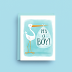 Greeting card with stork holding an egg labeled 'it's a boy!' on a light blue background