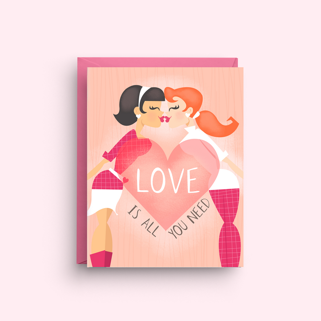 Greeting card with two people embracing and a heart with 'LOVE IS ALL YOU NEED' text on a pink background