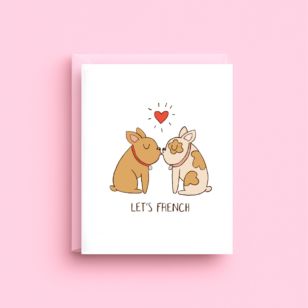 Greeting card with two dogs kissing and a heart above them on a pink background