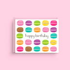 Greeting card with colorful macaron illustrations and 'happy birthday' text on a pink background