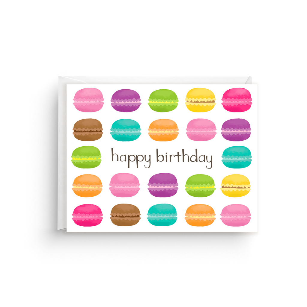 Greeting card with colorful macaron illustrations and 'happy birthday' text on a white background