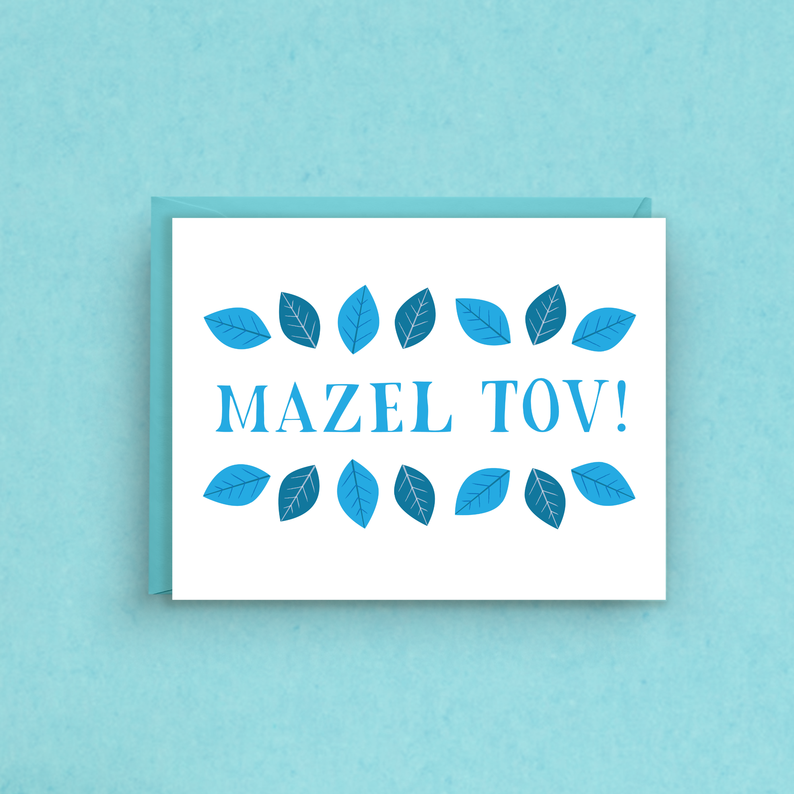 Greeting card with 'Mazel Tov!' text and blue leaf designs on a light blue background