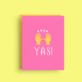 Pink card with yellow hands and 'YAS!' text on a yellow background
