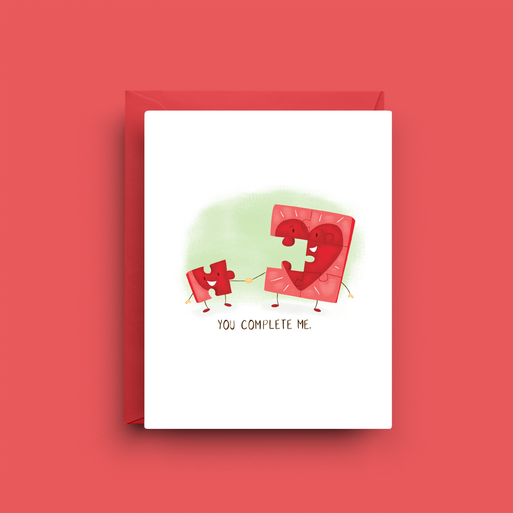 Greeting card with puzzle piece design on a red background