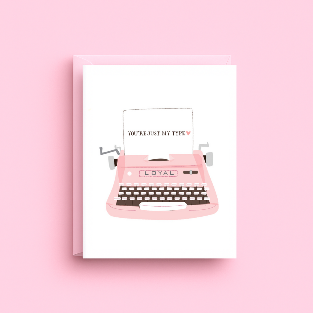Greeting card with a pink typewriter illustration on a pink background