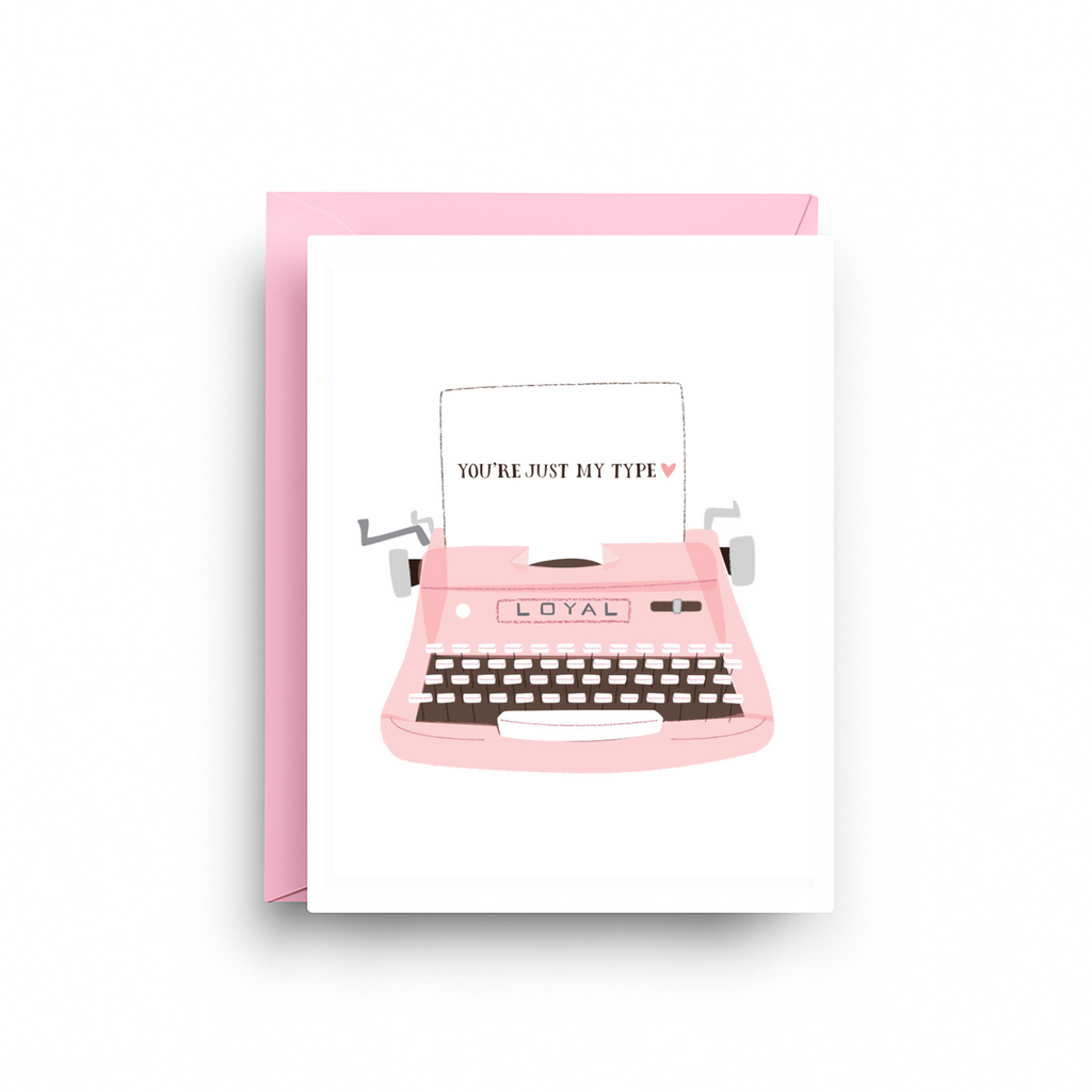 Greeting card with pink typewriter illustration and text on a white background
